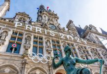 Paris, France - March 4, 2024: Facade of the town hall of Paris, France, decorated for the Olympic and Paralympic Games. Paris is the host city of the 2024 Summer Olympics