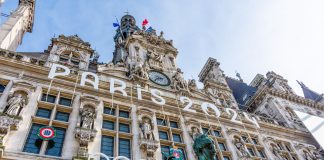 Paris, France - March 4, 2024: Facade of the town hall of Paris, France, decorated for the Olympic and Paralympic Games. Paris is the host city of the 2024 Summer Olympics