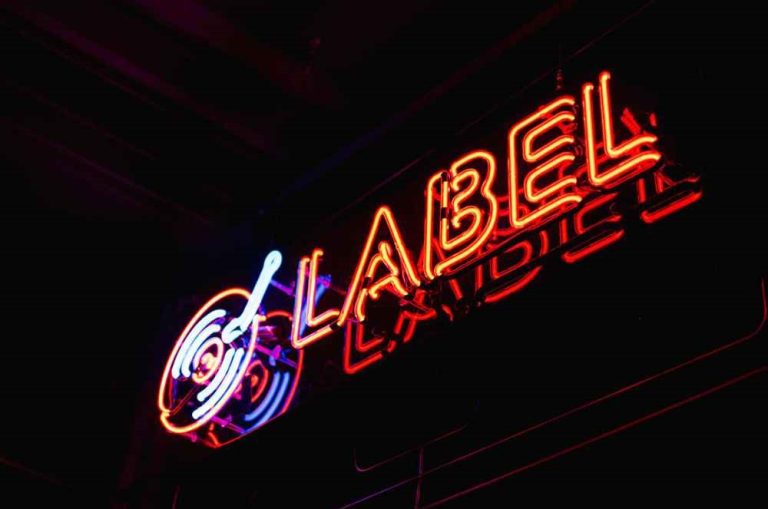 Independent label logo with emerging artist performing on stage