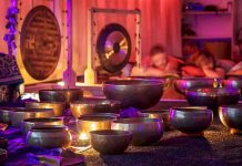 A serene sound bath session with singing bowls and chimes, representing the therapeutic use of vibrations.