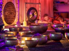 A serene sound bath session with singing bowls and chimes, representing the therapeutic use of vibrations.