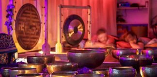 A serene sound bath session with singing bowls and chimes, representing the therapeutic use of vibrations.