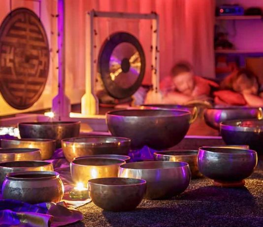 A serene sound bath session with singing bowls and chimes, representing the therapeutic use of vibrations.