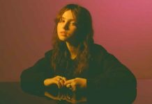 Clairo performing live, reflecting on the emotional depth of her music.