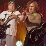 Jack Black performing on stage with his band Tenacious D