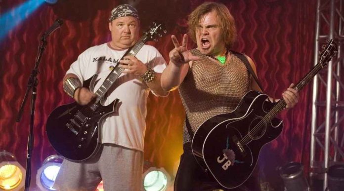 Jack Black performing on stage with his band Tenacious D