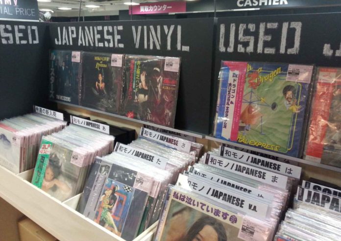 A vintage record player playing a Japanese City Pop vinyl, symbolizing the genre’s global resurgence.