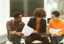 A musician meeting with their team, discussing contracts and strategy.