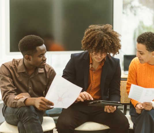 A musician meeting with their team, discussing contracts and strategy.