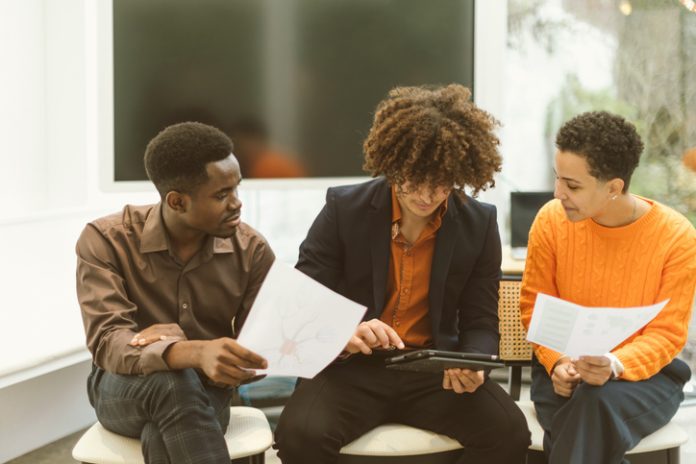 A musician meeting with their team, discussing contracts and strategy.